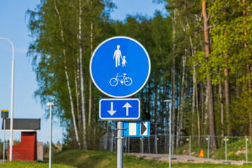 Close up view of blue road sign for pedestrians and bicycles lane. Sweden. 
