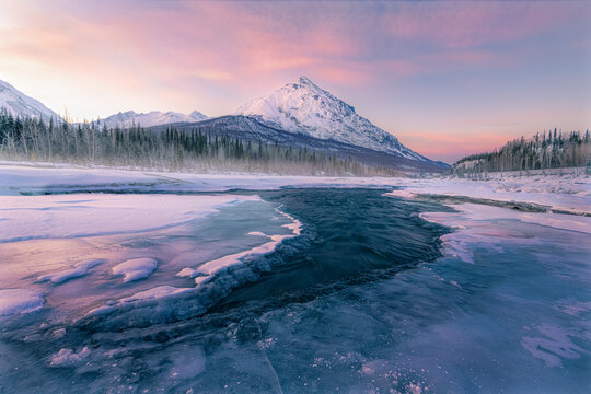 lake in front of mountain at sunset
