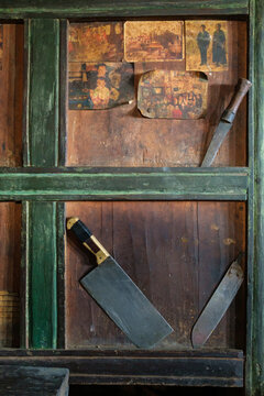 Old photos and knives on the wall of a house in a mountain village. Langtang National Park. Nepal.