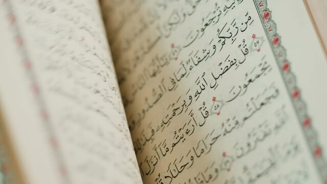 The Holy Quran Book, koran Chapter, flipping pages Close up Macro.