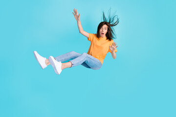 Full length photo of anxious embarrassed girl person look empty space fly down isolated on blue color background