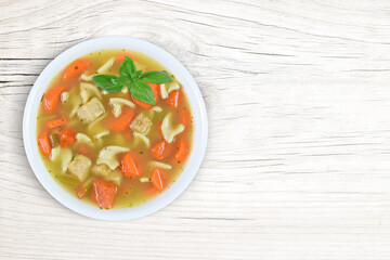 Chicken Noodle Soup Remedy on Modern White Wood Background with Copy Space