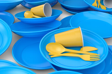 Heap of disposable utensils like plate, folk, spoon,knife and cup on white.