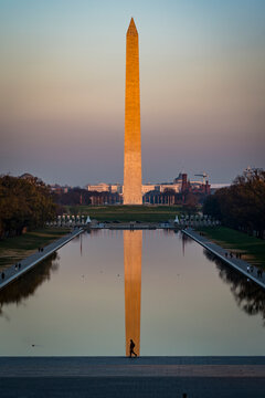 The Washington Monument at sunset with a lone walker, Washington DC