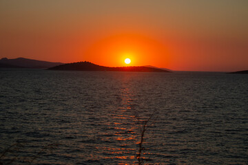 sunset from the beach behind the island