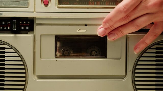 Retro radio tape recorder close-up. Listening to music, using cassette, old radio boombox player, searching channel. 