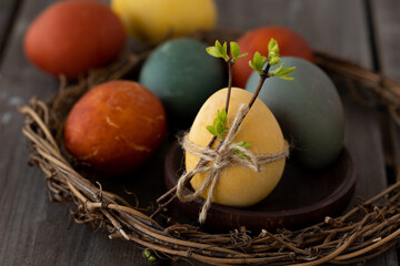 Easter eggs coloured with natural organic colorants: red cabbage, curcuma, onion peel. Handmade home decor, natural elements, eco-friendly, zero waste. Dark wooden background