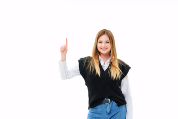 a blonde in a black vest shows fingers up on a white background
