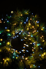 Fototapeta na wymiar New Year 2023. Christmas beautiful lights bokeh on gold warm background. Defocused Lights on a Tree Background. Christmas tree toys. Golden abstract blinking blurred.