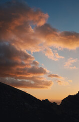 Beautiful sunset in the mountains. Clouds over the sea at sunset.