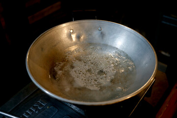 Boiling water in the pan at night. 