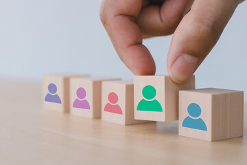 HRM Banner. Team building and diversity concept. Work collaboration for achieving goal and successful business. Productive people skills. Hand placed wooden cubes with team diversity building icons.