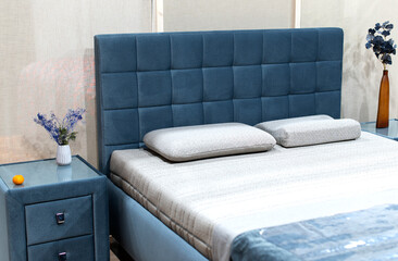 Gray pillow on blue bed decoration in bedroom interior