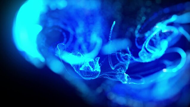 Background of shiny ink effect advection. injection of fluorescent blue ink in water in 4k. 3d render of glow particles in ink flow. Luma matte as alpha channel.