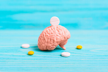 Human brain and pills on blue background