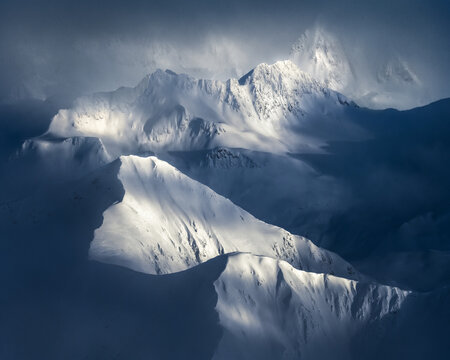 Snow capped mountains with fog.