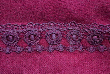 red texture of woolen fabric with a pattern on the part of the scarf