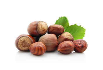 Heap of hazelnuts in shell and peeled kernels with leaves isolated on white background