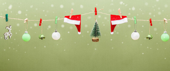 Fototapeta na wymiar Festive New Year background. Traditional symbols hanging on the thread: fir tree, Christmas balls