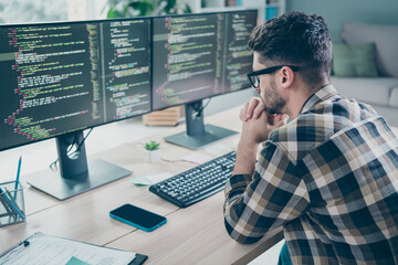 Photo of minded ponder guy wear glasses arms hands chin typig code modern device indoors workstation workshop home