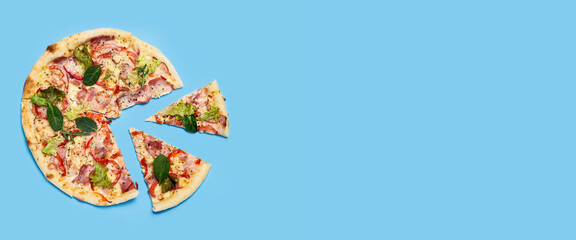 cut into slices fresh hot pizza on blue background. Top view, flat lay. Banner