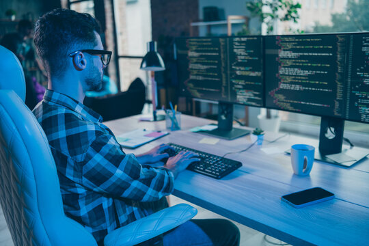 Photo of serious busy guy wear glasses writing safety code modern device indoors workstation workshop home
