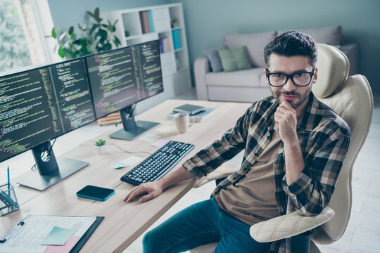 Photo of busy smart programmer wear spectacles arm hand chin testing modern device system indoors workplace workshop home