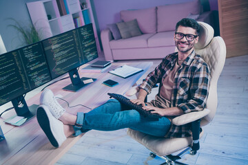 Full length profile portrait of positive clever database operator sit chair put legs table keyboard...