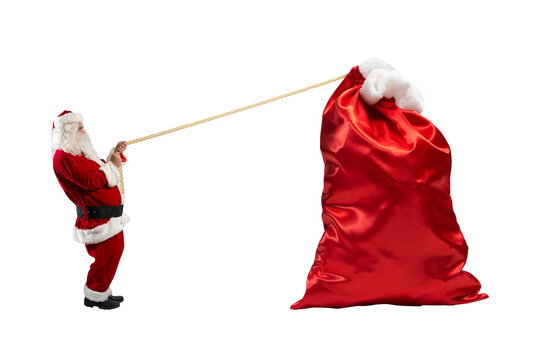 santa claus pulls a rope to move a big sack full of gifts