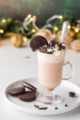 Cookies and cream hot cocoa topped with whip cream and cookie crumbs.