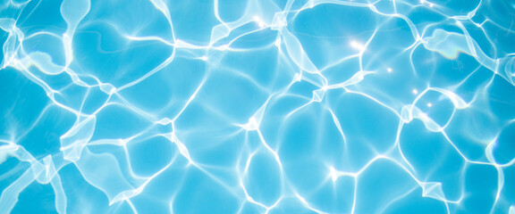 Fototapeta na wymiar Clear blue water in the pool under the rays of the sun. Banner