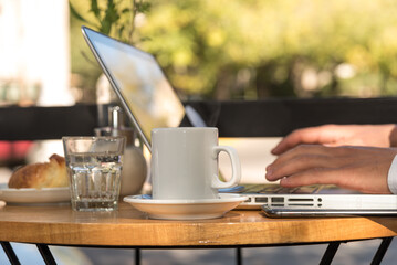 man outdoors working on his laptop