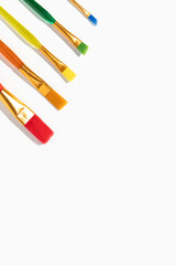 Colored brushes for drawing on a white background. Top view, flat lay