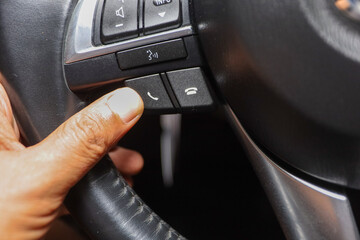 Driver pushes engine start button on modern car.  keyless engine starting system