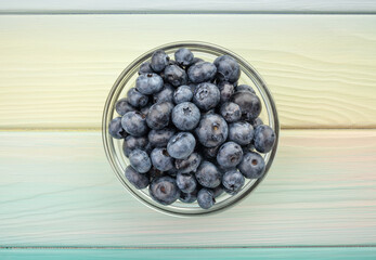 blueberry bowl on wood background top view