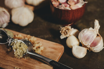 garlic press with garlic cloves