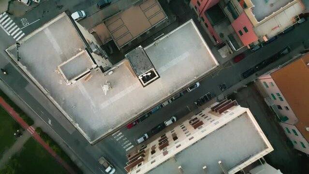Aerial flight over rooftops in Sestri Levante. We see streets and city trafiic with cars.