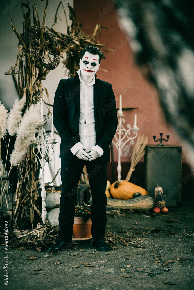 Poster serbian man wearing a joker character during halloween