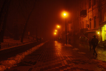 Fototapeta na wymiar Night path with mystical red light. The city is in the fog. The effect of soft focus, sleep.