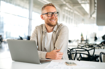 Positive smart successful caucasian man, with glasses, in stylish casual wear, IT specialist,...