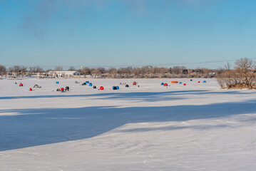 Fototapeta na wymiar Ice Fishing On The River In January In Wisconsin