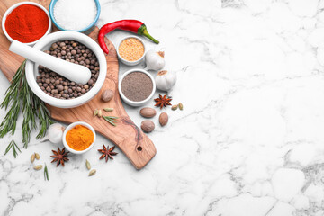 Flat lay composition with mortar and different spices on white marble table, space for text