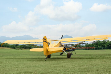 View of beautiful ultralight airplanes in field on autumn day