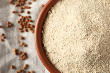 Bowl of buckwheat flour on cloth, top view