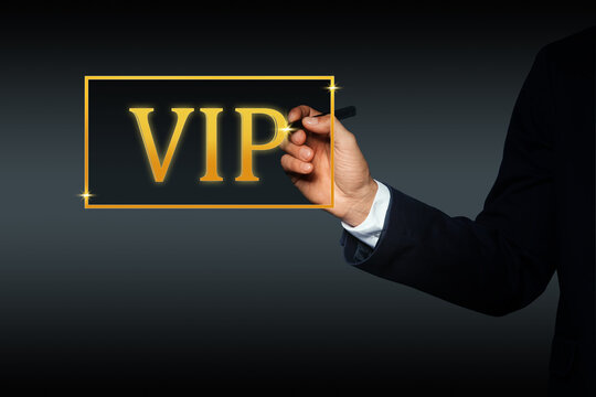 VIP member. Closeup view of man pointing at virtual abbreviation on dark background