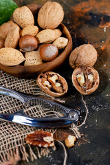 nuts in wooden bowl. Food mix background,  Assortment of nuts - cashew, hazelnuts, almonds, walnuts, pistachio, pecans, pine nuts, peanut, raisins.