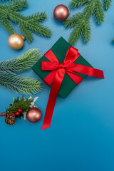 Christmas composition. festive decor on blue background. Copy space, flat lay, top view.