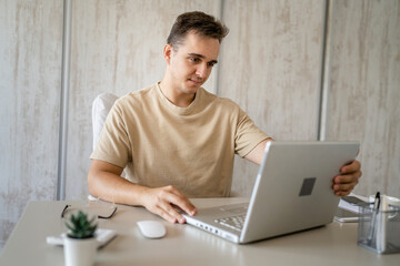 one man young adult caucasian male work on laptop computer in office