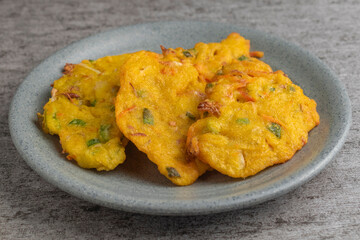 bakwan is vegetable fritter from Indonesia. made from mixed vegetable and flour fried in cooking oil
