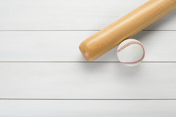 Baseball bat and ball on white wooden table, top view with space for text. Sports equipment
